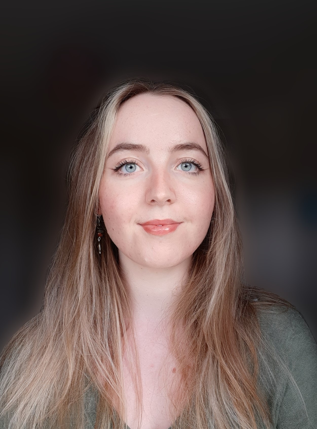image of daisy hanson. A Caucasian woman with blond hair and a round face, and wide blue eyes.
