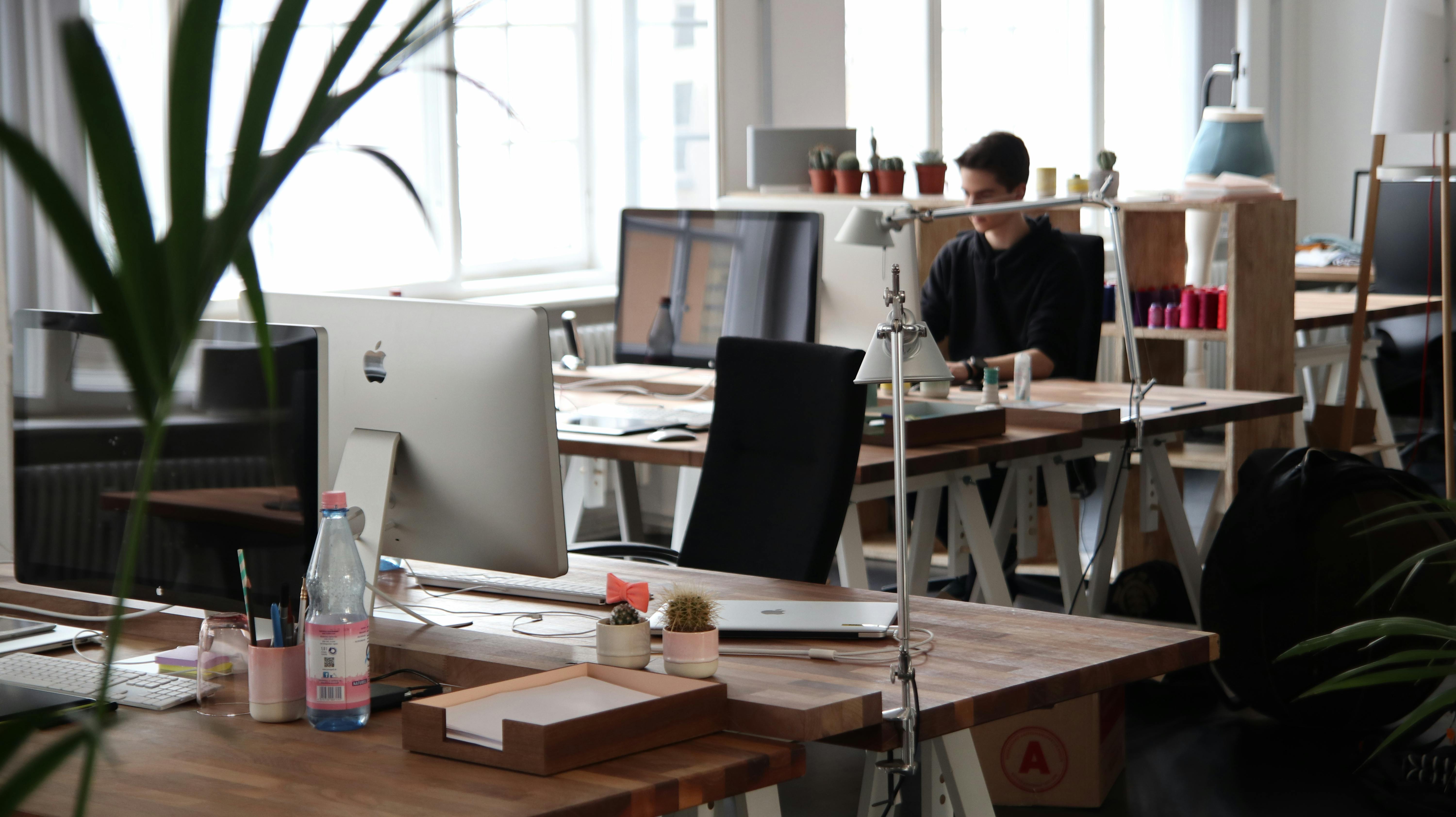 Stock Image of a traditional office workspace with computers and desks