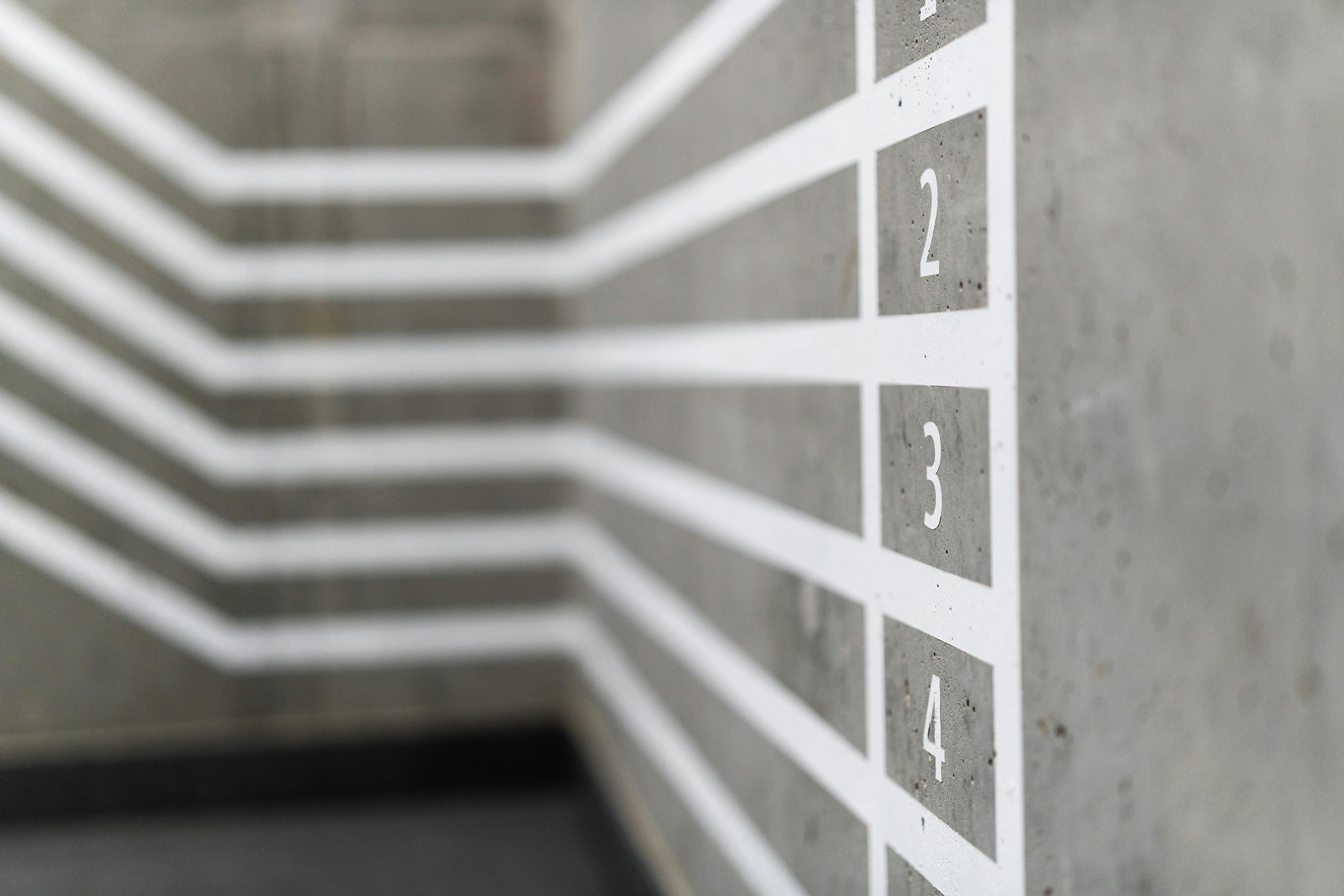 pexels-jakubzerdzicki-20790153 white numbers lined up on a wall