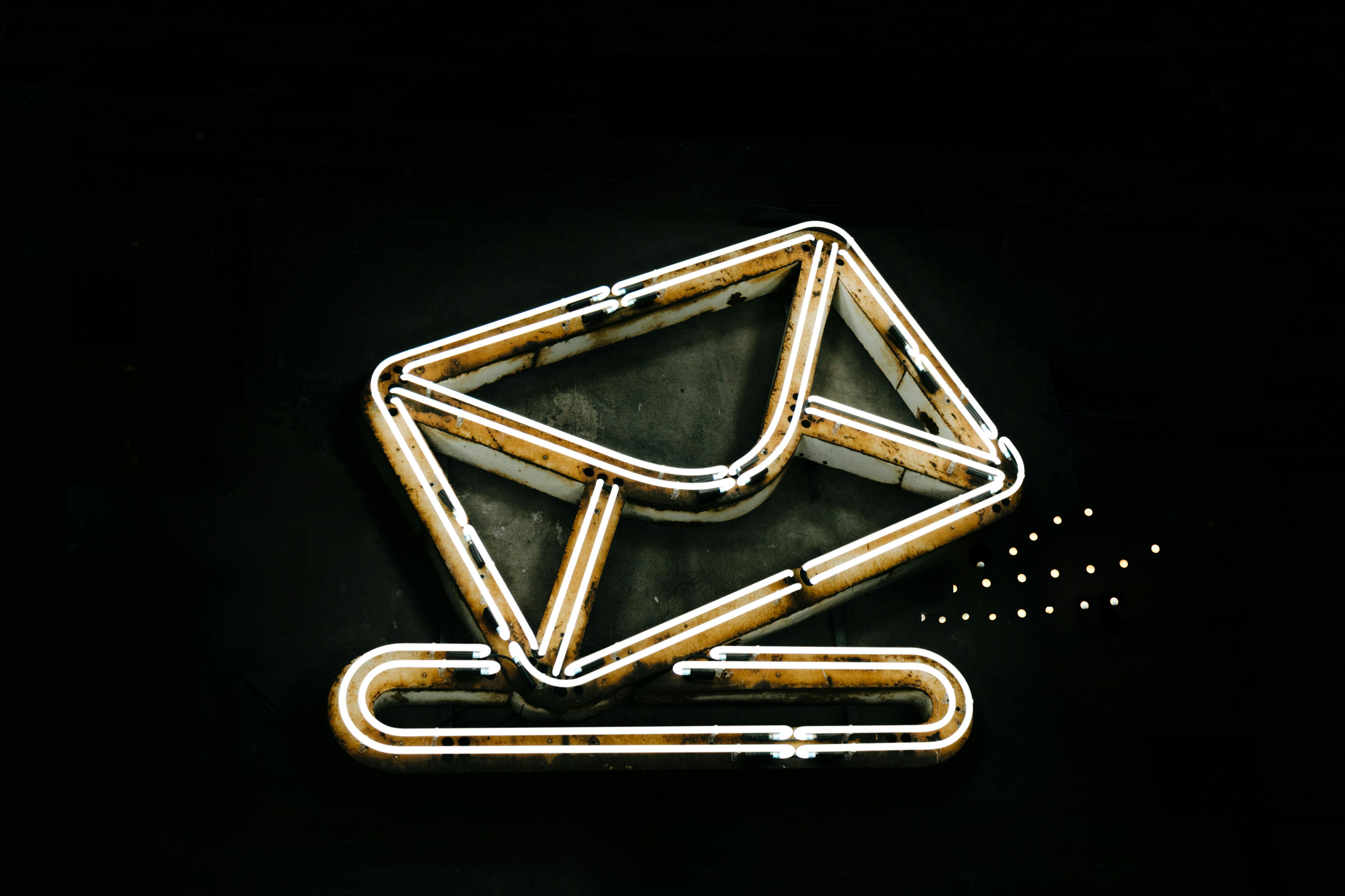neon light of an envelope being posted, or an icon of an email messaging app.